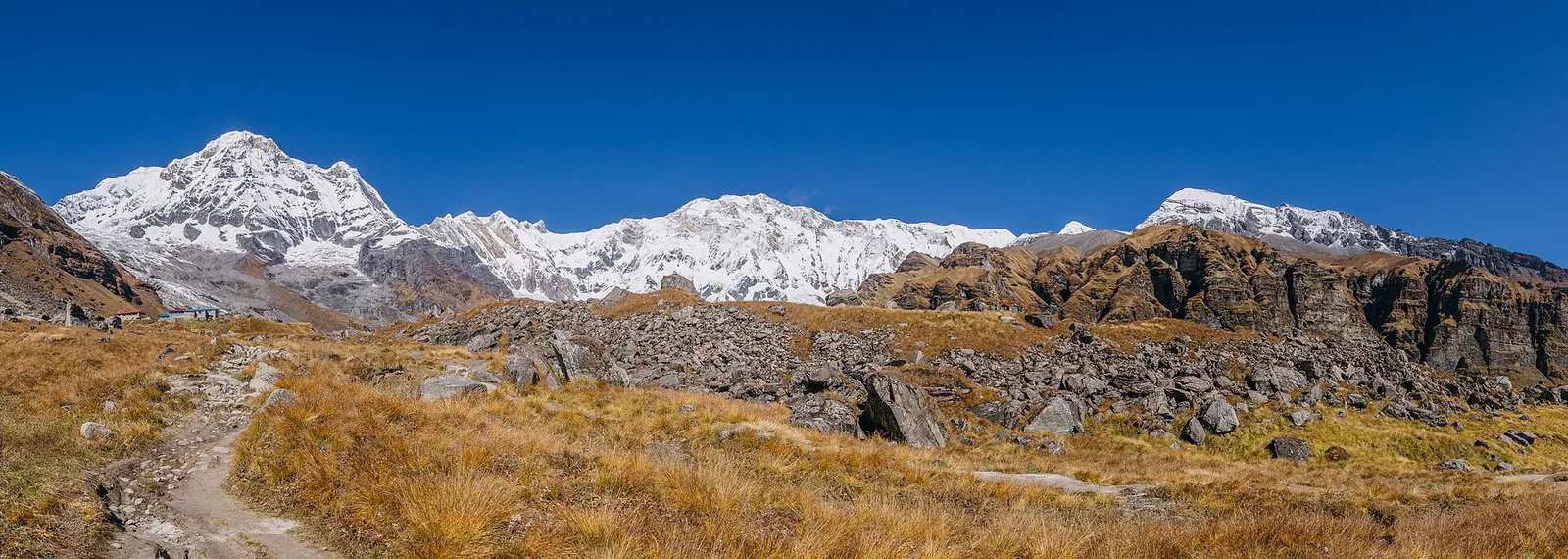 Snow-covered Annapurna peaks rising above a Himalayan valley in Nepal
