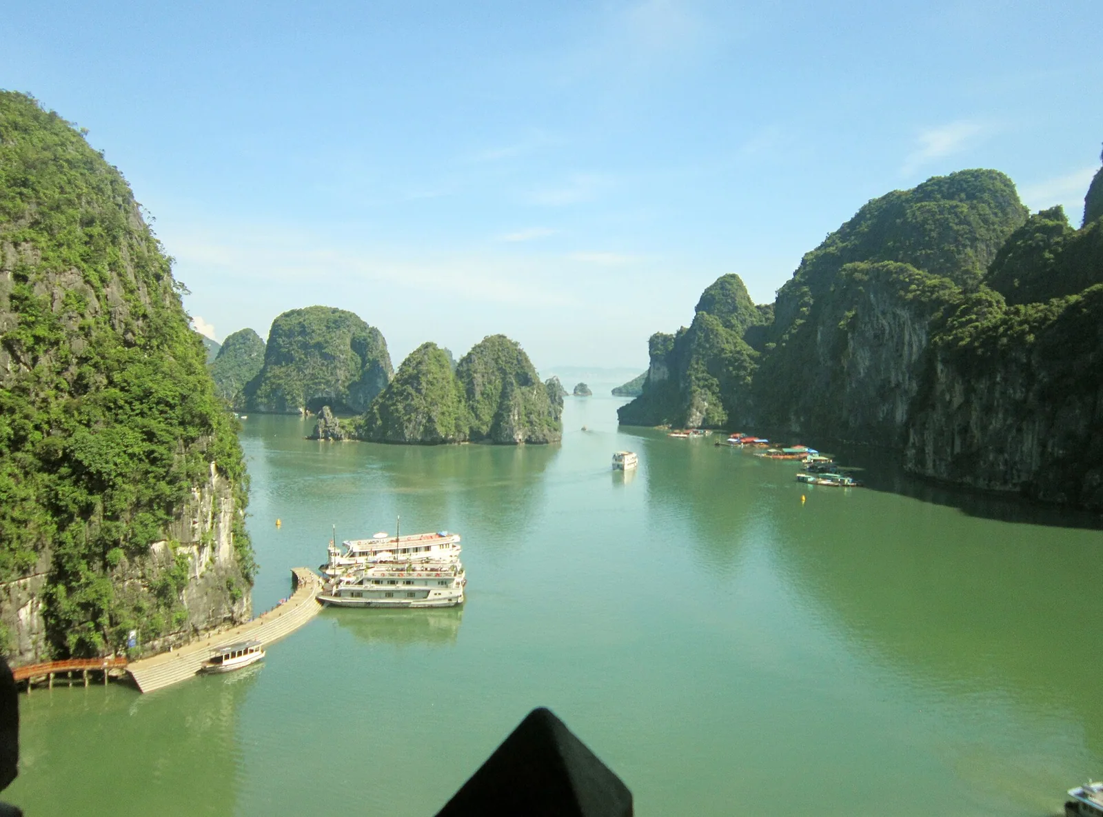 Limestone karsts rising from the calm water of Ha Long Bay, Vietnam